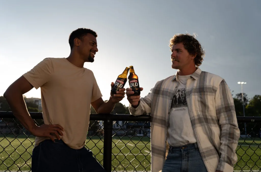Toasting with bottles of Tooheys Old